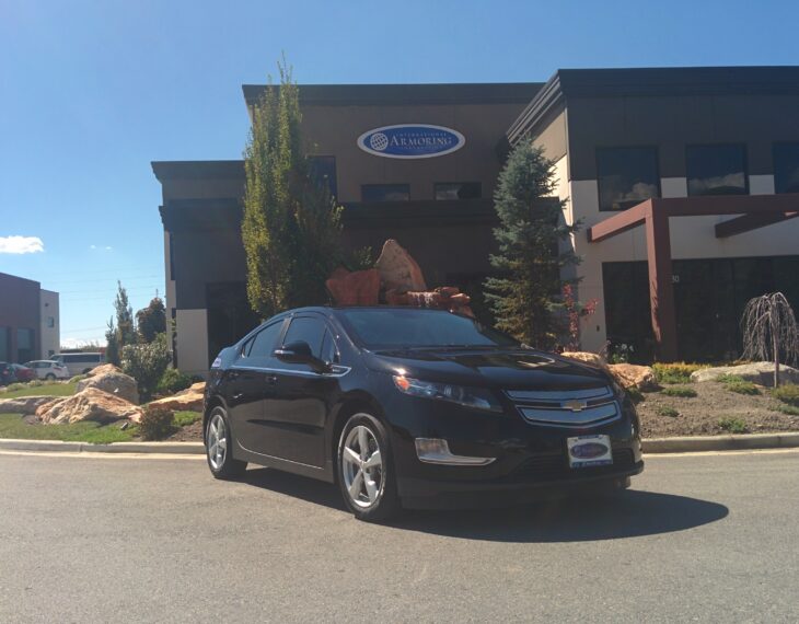 Bulletproof Chevy Volt in front of Armormax Utah facility